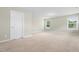 Bright bedroom features carpet flooring, two windows bringing in natural light and a closet at 2901 Murray Ridge Trl, Apex, NC 27502
