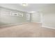 Large bonus room with neutral carpet, bright lighting, and comfortable living space at 2901 Murray Ridge Trl, Apex, NC 27502