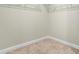 View of empty walk-in closet with beige carpeting and metal rack shelving installed at 2901 Murray Ridge Trl, Apex, NC 27502