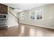 Open dining area featuring hardwood floors, lots of natural light, and a modern chandelier at 2901 Murray Ridge Trl, Apex, NC 27502