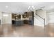 Open-concept kitchen featuring a large island, stainless steel appliances, and hardwood floors at 2901 Murray Ridge Trl, Apex, NC 27502