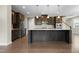 Modern kitchen with a large island, stainless steel appliances, and dark wood cabinets at 2901 Murray Ridge Trl, Apex, NC 27502