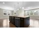 Island kitchen featuring a dishwasher, sink, and an overhang for eating at 2901 Murray Ridge Trl, Apex, NC 27502