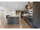 Spacious kitchen featuring stainless steel appliances, a large island, and dark cabinets at 2901 Murray Ridge Trl, Apex, NC 27502