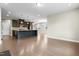 Bright open-concept kitchen boasts hardwood floors, dark cabinets, and a stylish center island at 2901 Murray Ridge Trl, Apex, NC 27502