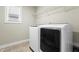 Bright laundry room features tile flooring, a washer and dryer, a window and wire shelving at 2901 Murray Ridge Trl, Apex, NC 27502