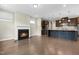 Spacious living room featuring a cozy fireplace, hardwood floors, and an open flow to the kitchen at 2901 Murray Ridge Trl, Apex, NC 27502