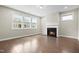 Bright living room with a fireplace and large windows offering plenty of natural light at 2901 Murray Ridge Trl, Apex, NC 27502