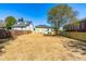 Large fenced backyard features new landscaping, a wooden fence, and stairs up to the rear entrance at 314 Bledsoe Ave, Raleigh, NC 27601