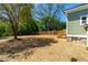 Wide view of the backyard with wooden fence, fresh landscaping, and stairs up to the home at 314 Bledsoe Ave, Raleigh, NC 27601