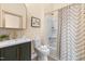Bathroom featuring a framed mirror above a vanity with gold hardware and a patterned shower curtain at 314 Bledsoe Ave, Raleigh, NC 27601