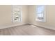 Bright empty bedroom with neutral walls, new flooring, and good natural light from two large windows at 314 Bledsoe Ave, Raleigh, NC 27601