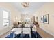 Elegant dining area with a modern black table and white chairs, complemented by contemporary lighting fixtures at 314 Bledsoe Ave, Raleigh, NC 27601