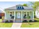 Charming home featuring a covered porch, light green siding, well-manicured lawn, and inviting curb appeal at 314 Bledsoe Ave, Raleigh, NC 27601