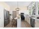 Modern kitchen with white cabinetry, stainless steel appliances, a kitchen island, and wood-look flooring at 314 Bledsoe Ave, Raleigh, NC 27601