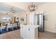 View of the kitchen with stainless steel refrigerator, white cabinets, and view of the dining area at 314 Bledsoe Ave, Raleigh, NC 27601