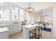 Bright, open kitchen with white cabinets, large windows, and a view to the living and dining areas at 314 Bledsoe Ave, Raleigh, NC 27601