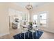 Bright kitchen and dining area featuring white cabinets, a center island, modern appliances, and natural lighting at 314 Bledsoe Ave, Raleigh, NC 27601