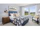 Bedroom featuring a striped headboard, stylish sconces, and a scenic view out of large, sun-filled windows at 315 Adams Pointe Ct, Angier, NC 27501