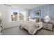 Comfortable bedroom featuring wallpaper accent wall, plush carpeting, and natural light streaming from large windows at 315 Adams Pointe Ct, Angier, NC 27501