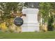 A decorative brick sign with the name 'Honeycutt Hills' set against a backdrop of trees and greenery at 315 Adams Pointe Ct, Angier, NC 27501