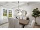 An elegant dining room with a wooden table, decorative lighting, and a window view of the outdoors at 315 Adams Pointe Ct, Angier, NC 27501