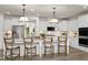 Bright kitchen featuring white cabinets, stainless steel appliances, and a spacious island with seating at 315 Adams Pointe Ct, Angier, NC 27501