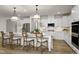 A modern kitchen with white cabinetry, pendant lighting, and an island with bar stool seating at 315 Adams Pointe Ct, Angier, NC 27501