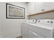Efficient laundry room featuring a Whirlpool washer and dryer, overhead storage, and ample counter space at 315 Adams Pointe Ct, Angier, NC 27501