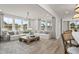 A bright living room featuring light furniture, a wooden coffee table, and large windows at 315 Adams Pointe Ct, Angier, NC 27501