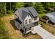 Aerial view of a modern two-story home showing the landscaping, driveway, and surrounding greenery at 3221 Skycrest Dr, Raleigh, NC 27604