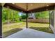 View of a covered back patio with wood ceiling and concrete pad to relax in the backyard at 3221 Skycrest Dr, Raleigh, NC 27604