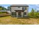 Backyard view of a two story home, covered patio, and plenty of outdoor space to enjoy at 3221 Skycrest Dr, Raleigh, NC 27604