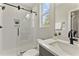 Modern bathroom featuring a glass shower, quartz counters, and a window providing natural light at 3221 Skycrest Dr, Raleigh, NC 27604