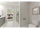 Modern bathroom featuring elegant tile flooring, a glass shower, and access to the main bedroom at 3221 Skycrest Dr, Raleigh, NC 27604