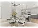 Elegant dining room with modern lighting fixtures adjacent to the kitchen, perfect for entertaining at 3221 Skycrest Dr, Raleigh, NC 27604