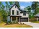 Two-story home featuring a modern farmhouse design with black trim and a two-car garage at 3221 Skycrest Dr, Raleigh, NC 27604