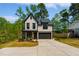 Two-story home featuring a modern farmhouse design with black trim and a two-car garage at 3221 Skycrest Dr, Raleigh, NC 27604