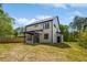 Back exterior view of a two-story home with an open backyard, patio, and yard space at 3221 Skycrest Dr, Raleigh, NC 27604