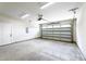 Spacious garage with concrete floor, white walls, and garage door entrance with plenty of room at 3221 Skycrest Dr, Raleigh, NC 27604