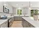 Spacious kitchen featuring stainless steel appliances, modern fixtures, and lots of natural light at 3221 Skycrest Dr, Raleigh, NC 27604