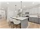 Stylish kitchen with an island, quartz countertops, stainless appliances and modern pendant lights at 3221 Skycrest Dr, Raleigh, NC 27604