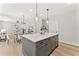 Kitchen island with seating and modern pendant lights overlooking the dining and living areas at 3221 Skycrest Dr, Raleigh, NC 27604