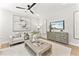 Bright living room with modern decor, ceiling fan, and beach-themed television display at 3221 Skycrest Dr, Raleigh, NC 27604