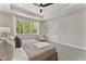 Well-lit main bedroom with ample natural light from windows and a tranquil view of the trees at 3221 Skycrest Dr, Raleigh, NC 27604