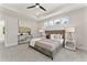 Cozy main bedroom featuring a ceiling fan, large windows, and stylish decor at 3221 Skycrest Dr, Raleigh, NC 27604