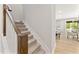 Staircase with carpeted steps and natural wood handrail, leading to the upper floors of the home at 3221 Skycrest Dr, Raleigh, NC 27604
