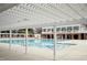 Resort-style community pool with a pergola, lounge chairs, and adjacent two-story clubhouse at 3300 Magical Pl, Raleigh, NC 27614