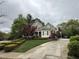 Beautiful home with stone and siding, a front porch, red maple trees, and long driveway at 3300 Magical Pl, Raleigh, NC 27614