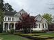 Charming home with stone and siding, front porch, a red maple tree, and manicured landscaping at 3300 Magical Pl, Raleigh, NC 27614